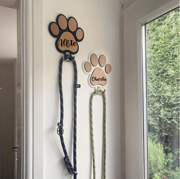 Personalized wooden paw print leash holder engraved with a pet's name