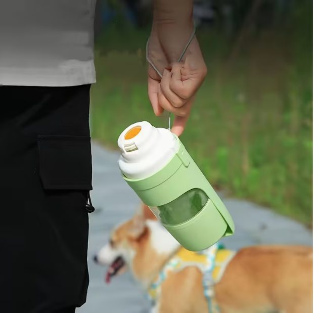 Carrying the Fidelo portable dog water bottle on a walk with a dog